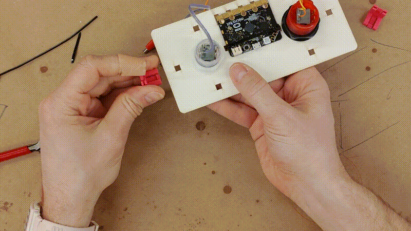 a short video clip showing six Clip-Os getting pressed on to the back of the top panel
