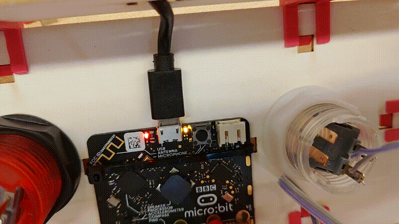 a short video clip showing the micro:bit programming LED flashing as a new program is loaded